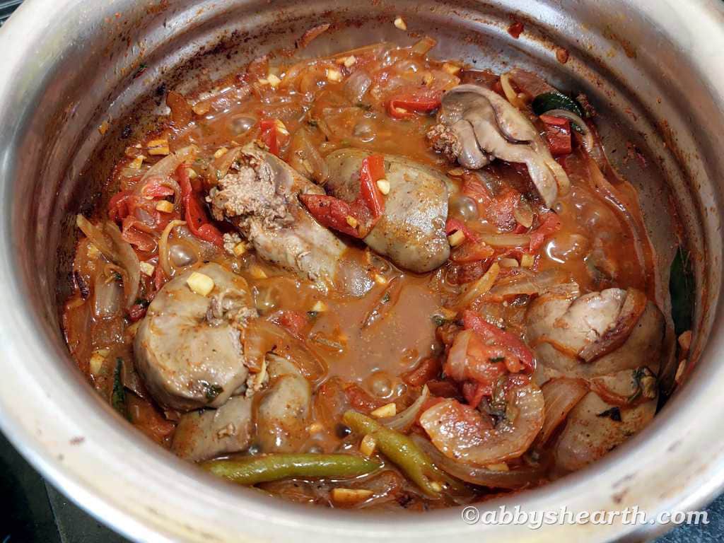 Chicken liver stir fry with vegetables in a cooking pot.