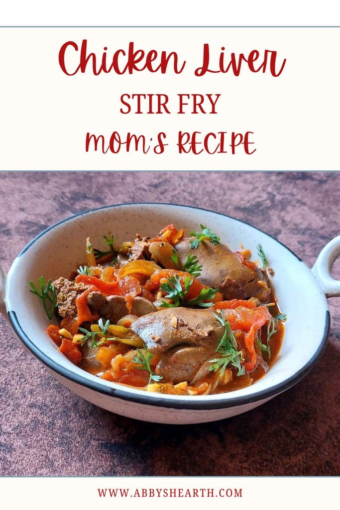 Delicious chicken liver stir fry with vegetables and herbs in a white bowl.