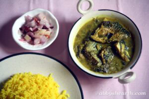 Hilsa khujit curry with turmeric rice and salad.