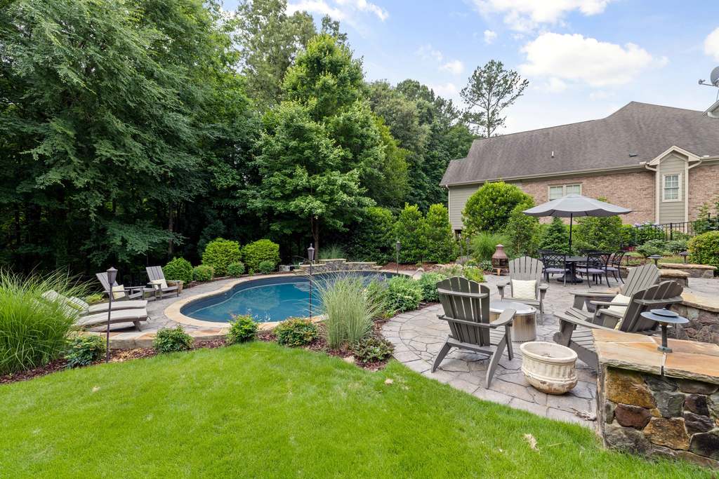 Backyard pool near a patio.