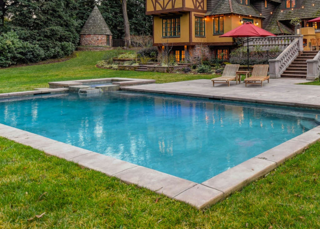 Backyard pool near a beautiful house.