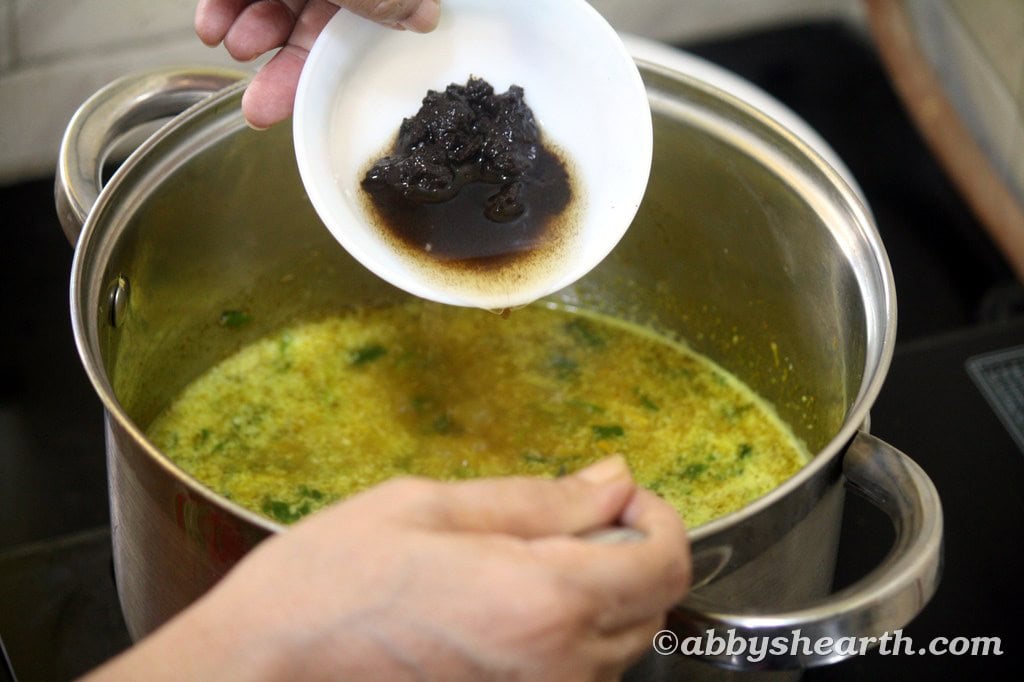 Add tamarind pulp to the pot.