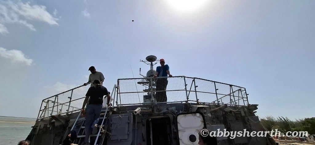 Dad on top of the naval ship's deck during daytime.