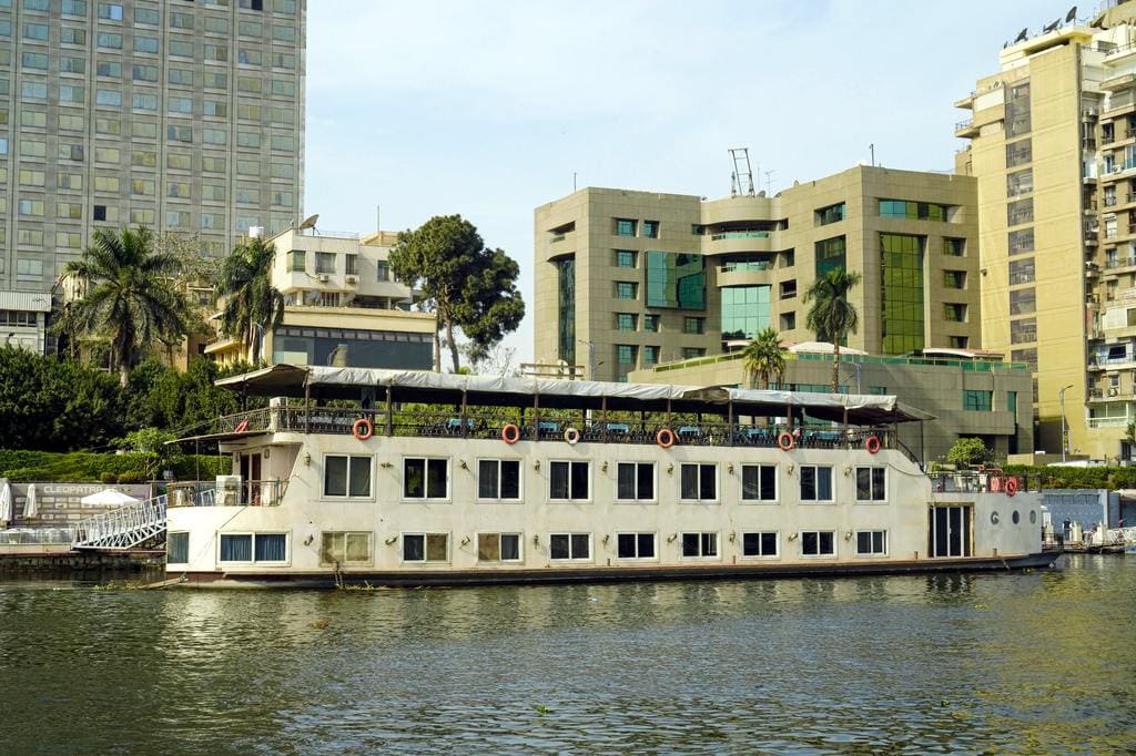 River cruise boat with cityscape background in Cairo, Egypt.