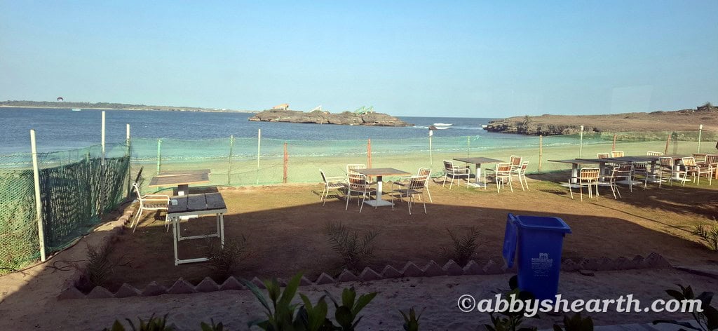 Outdoor seating with tables overlooking the beach and ocean view.
