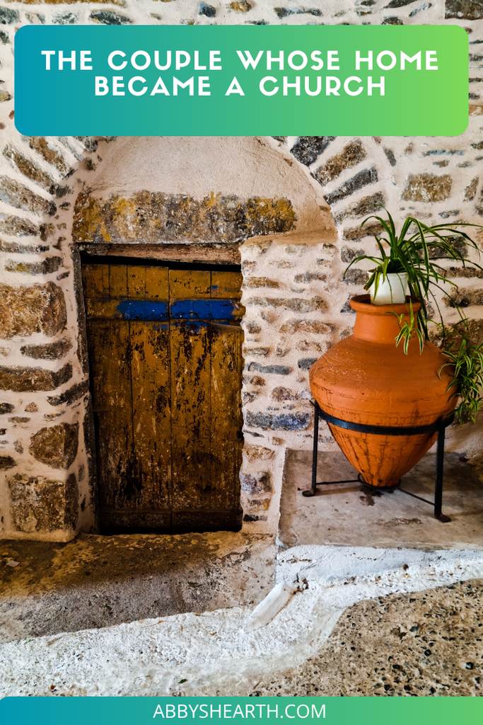 Stone doorway with potted plant in Cyrpus, emphasizing home and community.