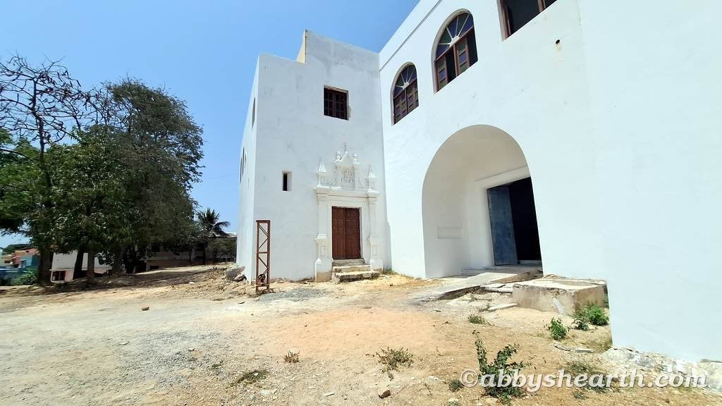 Side entrance to St Thomas Church with blue sky in Diu, India.