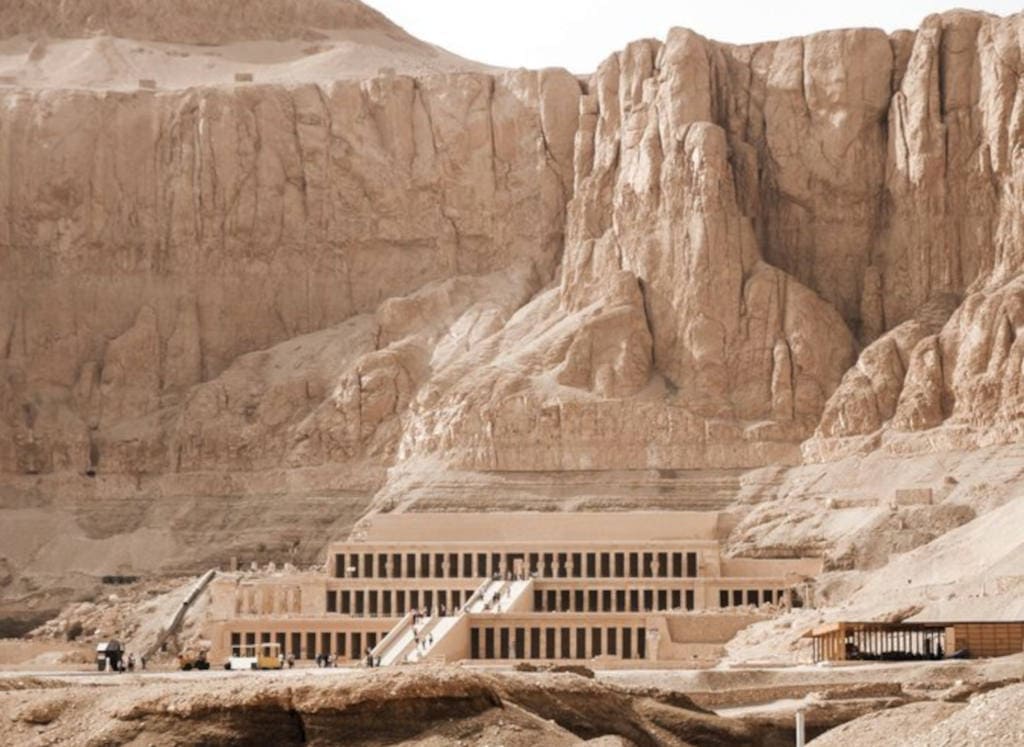Tomb of Hatshepsut carved into desert cliffs in the Valley of the Kings.