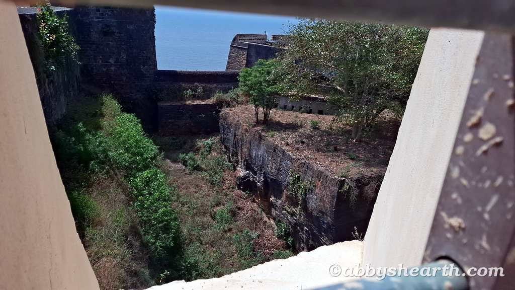 Ancient fortress ruins with greenery and sea view in Diu.